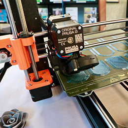 3D Printer in the process of printing a tray of Champlain shields